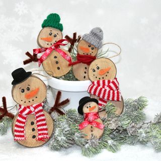 Funny snowmen made from wooden discs