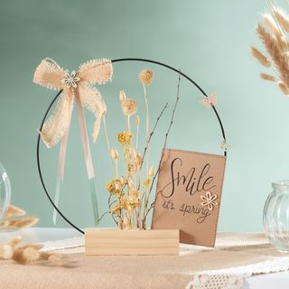 Decorative ring in wooden stand with dried flowers 